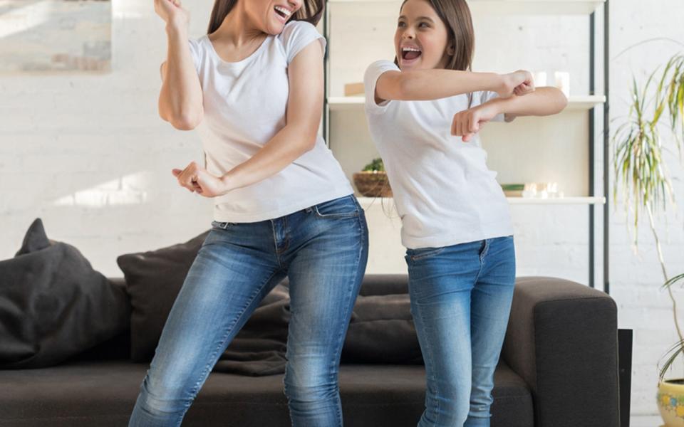 woman and girl dancing together