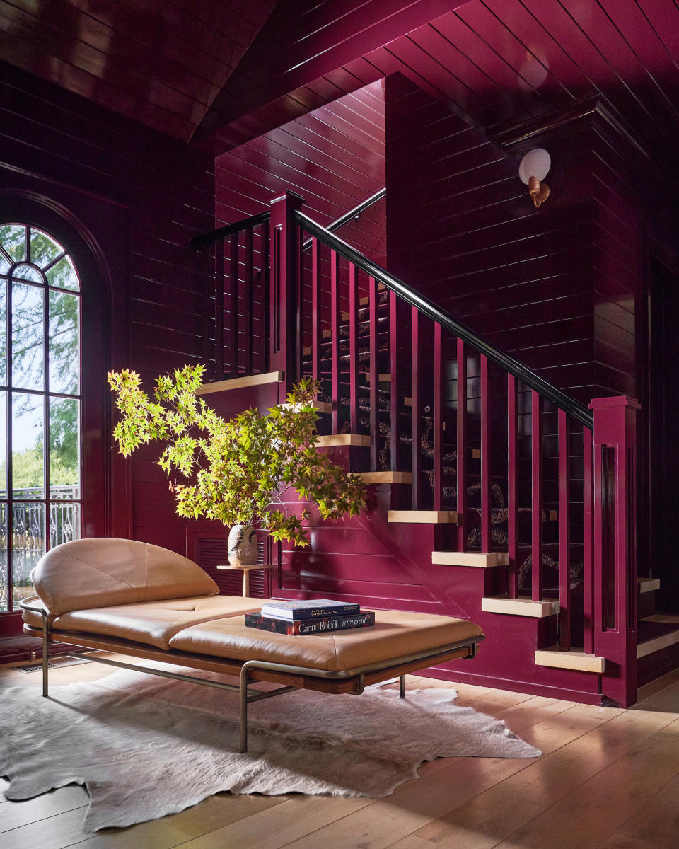 A wine-colored staircase painted in gloss paint