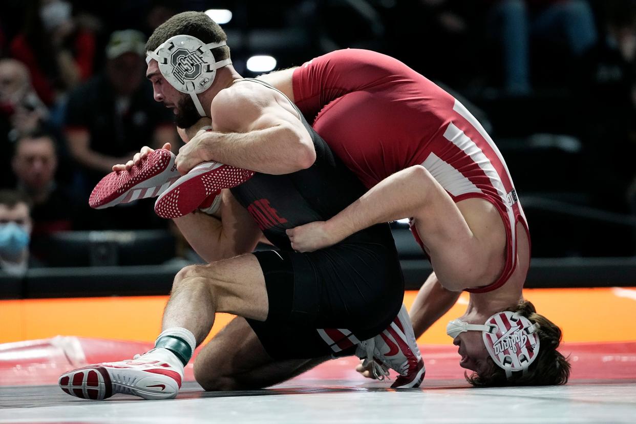 Ohio State's Sammy Sasso flips over Indiana's Graham Rooks at 149 pounds during the last regular season match of the season inside the Covelli Center at Ohio State University in Columbus, Ohio on February 13, 2022.