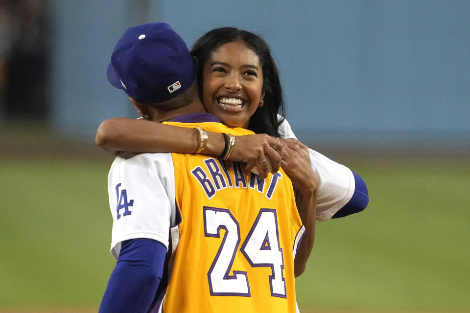 Natalia Bryant, daughter of Kobe Bryant, hugs Los Angeles Dodgers' Mookie Betts after throwing out the ceremonial first pitch prior to a baseball game between the Dodgers and the Atlanta Braves Friday, Sept. 1, 2023, in Los Angeles. (AP Photo/Mark J. Terrill)