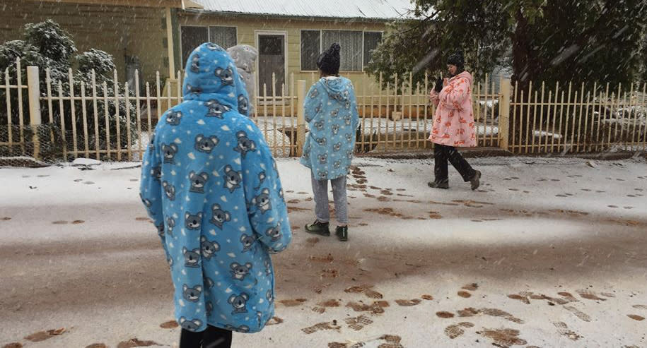 People at Skytrek Willow Springs Station walk in snow in South Australia