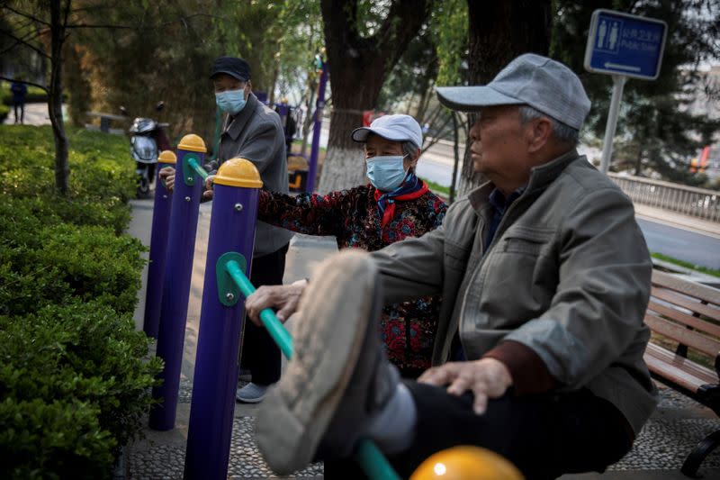 Elderly people exercise in a park in Beijing