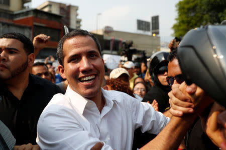 Venezuelan opposition leader Juan Guaido, who many nations have recognized as the country's rightful interim ruler, greets his supporters as he arrives to take part in a protest against Venezuelan President Nicolas Maduro's government in Caracas, Venezuela, April 10, 2019. REUTERS/Carlos Garcia Rawlins