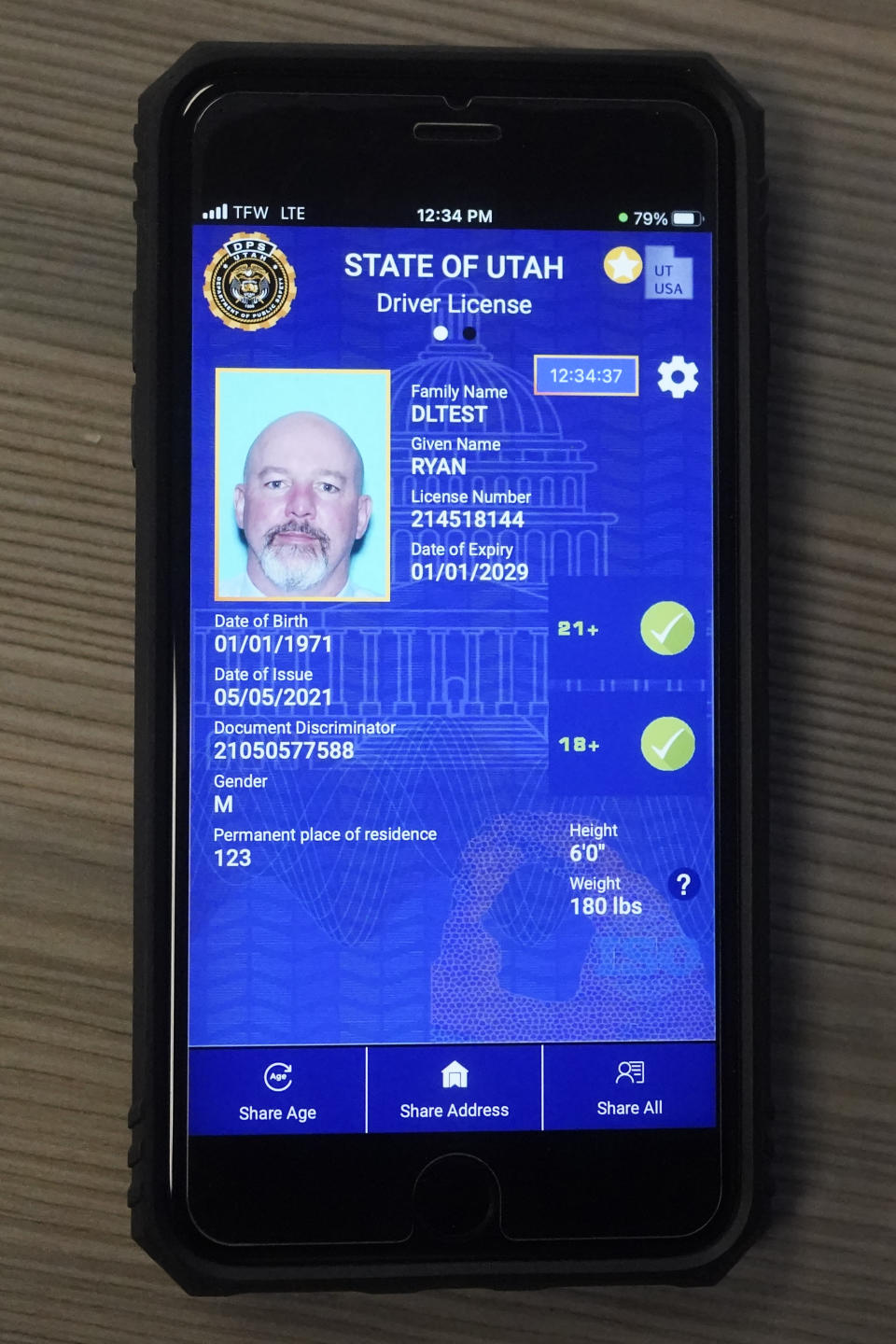 A cell phone with the pilot version of the Utah's mobile ID is shown on Wednesday, May 5, 2021, in West Valley City, Utah. The card that millions of people use to prove their identity to everyone from police officers to liquor store owners may soon be a thing of the past as a growing number of states develop digital driver's licenses. In Utah, over 100 people have a pilot version of the state's mobile ID, and that number is expected to grow to 10,000 by year's end. Widespread production is expected to begin at the start of 2022. (AP Photo/Rick Bowmer)