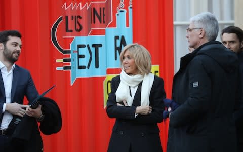 Brigitte Macron (C), wife of French President Emmanuel Macron, and her advisors look at products made in France displayed in the courtyard of the Elysee in Paris - Credit: AFP