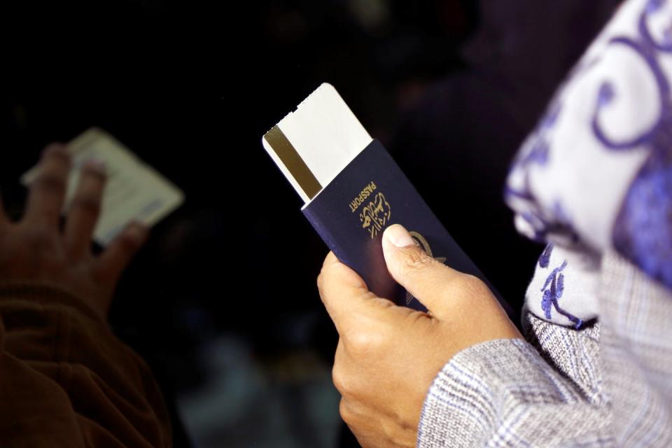 A passenger prepares to board a flight at Sanaa International Airport in Yemen on May 16, 2022. A truce in Yemen’s civil war enabled commercial flights to resume in 2022 for the first time in six years. <a href="https://www.gettyimages.com/detail/news-photo/passenger-holds-his-passport-and-boarding-pass-as-he-news-photo/1240718778" rel="nofollow noopener" target="_blank" data-ylk="slk:Mohammed Mohammed/Xinhua via Getty Images;elm:context_link;itc:0;sec:content-canvas" class="link ">Mohammed Mohammed/Xinhua via Getty Images</a>