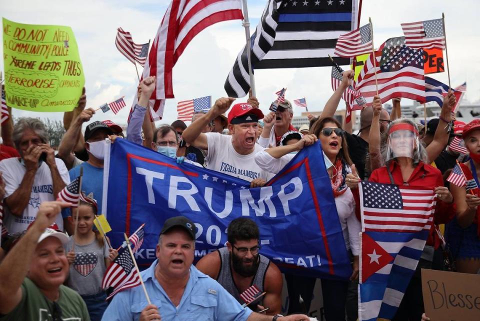 Rally attendees wave flags at the ‘Law and Order’ rally in support of local law enforcement and celebration of President Donald Trump’s birthday, Sunday, June 14, 2020.