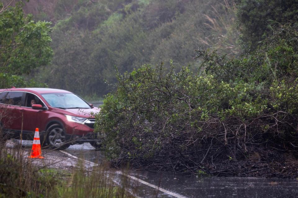 A driver is turned back by a mud slide blocking the road as the second and more powerful of two atmospheric river storms, and potentially the biggest storm of the season, arrives to Santa Barbara, California, on February 4, 2024. The US West Coast was getting drenched on February 1 as the first of two powerful storms moved in, part of a u0022Pineapple Expressu0022 weather pattern that was washing out roads and sparking flood warnings. The National Weather Service said u0022the largest storm of the seasonu0022 would likely begin on February 4.