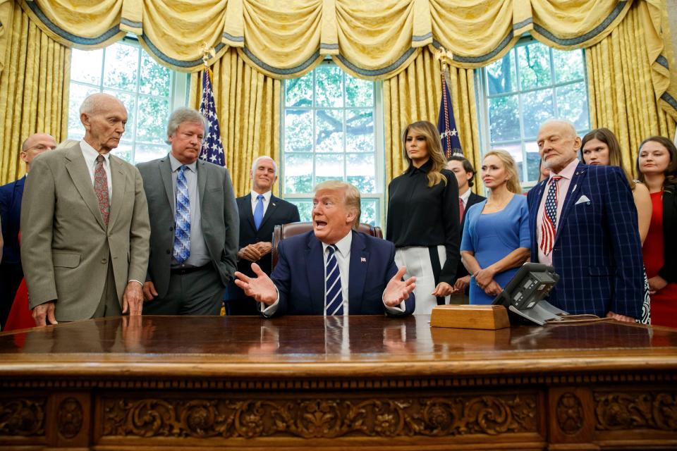 President Donald Trump, along with  Apollo 11 astronauts Michael Collins, left, and Buzz Aldrin, right, and Eric 