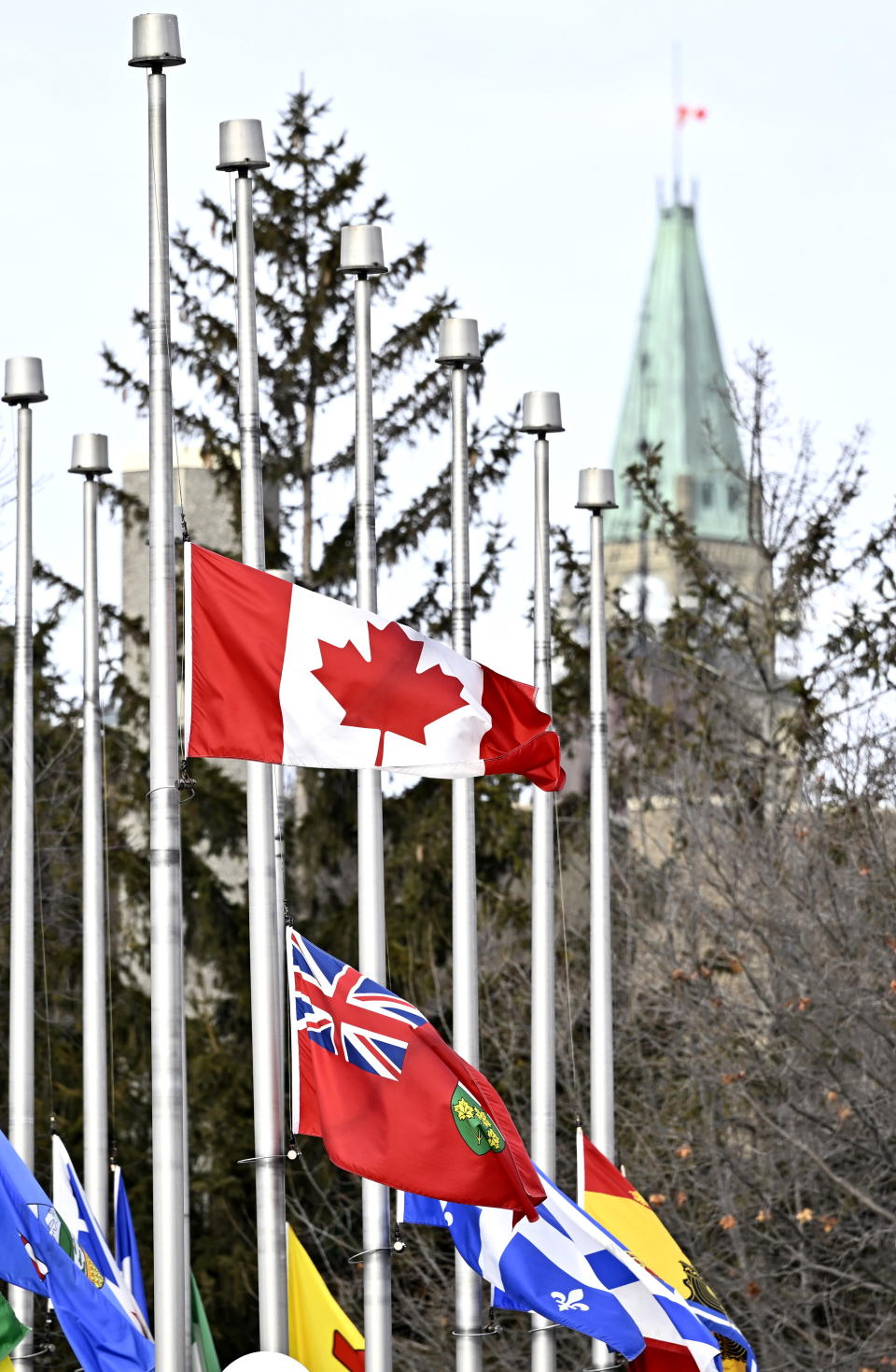 The flags in Ottawa's Confederation Park fly at half mast along with the flag atop Parliament Hill's Peace Tower after the death of former prime minister Brian Mulroney, on Friday, March 1, 2024. (Justin Tang