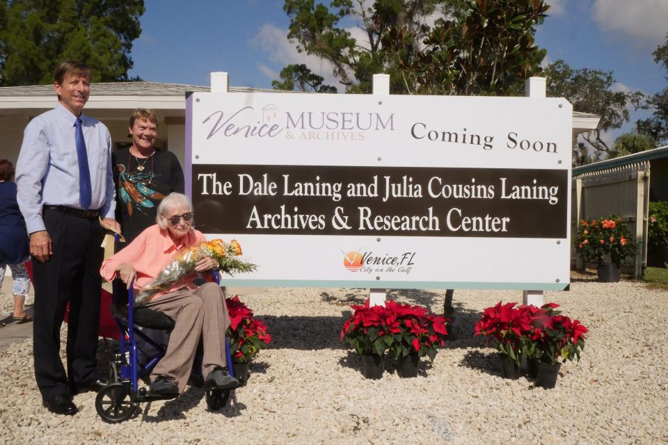 Jimmy Cousins, Julie Cousins and Julia Cousins Laning pose in front of the sign for the Dale Laning and Julia Cousins Laning Archives & Research Center, following a December 2017 unveiling center for the sign. Cousins Laning, who turned 100 in December, died on July 16.