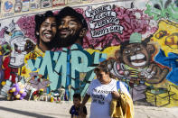 People gather in front of a mural in honour of former NBA star Kobe Bryant and his daughter Gianna in Los Angeles, California. (Credit: Ronen Tivony / Echoes Wire/Barcroft Media via Getty Images)