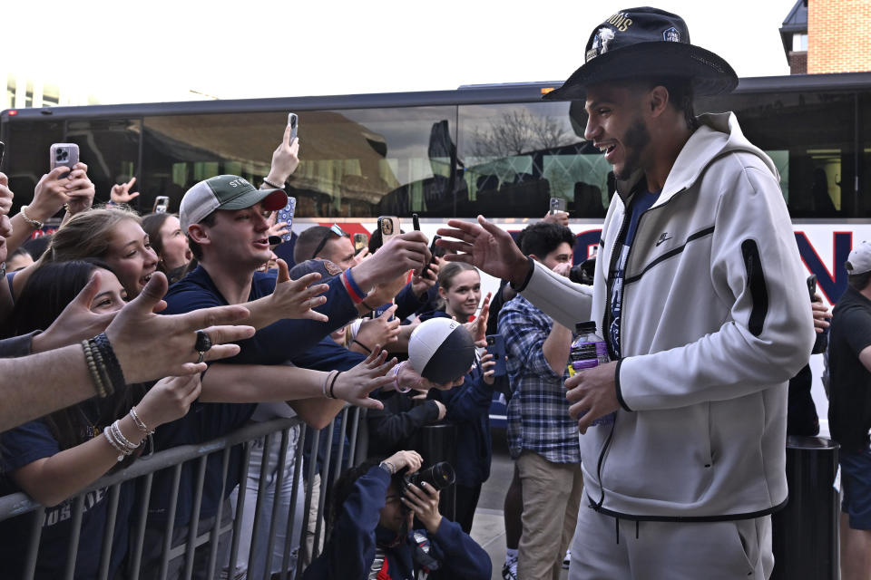UConn's Andre Jackson is greeted by fans as he arrives with the team for a rally at Gampel Pavilion celebrating the university's NCAA men's Division I basketball championship Tuesday, April 4, 2023, in Storrs, Conn. (AP Photo/Jessica Hill)