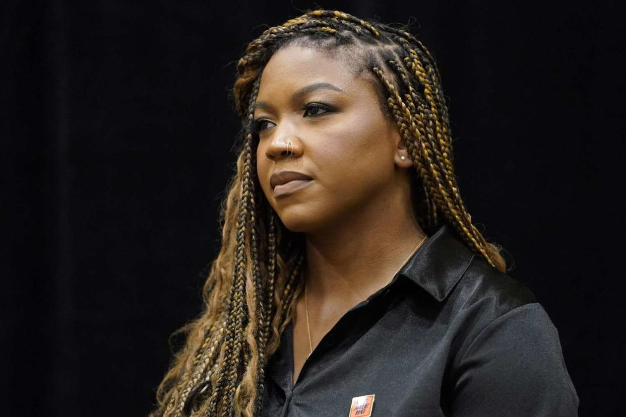 Cherelle Griner listens to the Rev. Al Sharpton at a news conference in Chicago, Friday, July 8, 2022. Cherelle Griner, wife of WNBA star Brittney Griner, joined Sharpton and WNBA players and union leaders a day after Brittney Griner pleaded guilty to drug possession charges in a Russian court. (AP Photo/Nam Y. Huh)