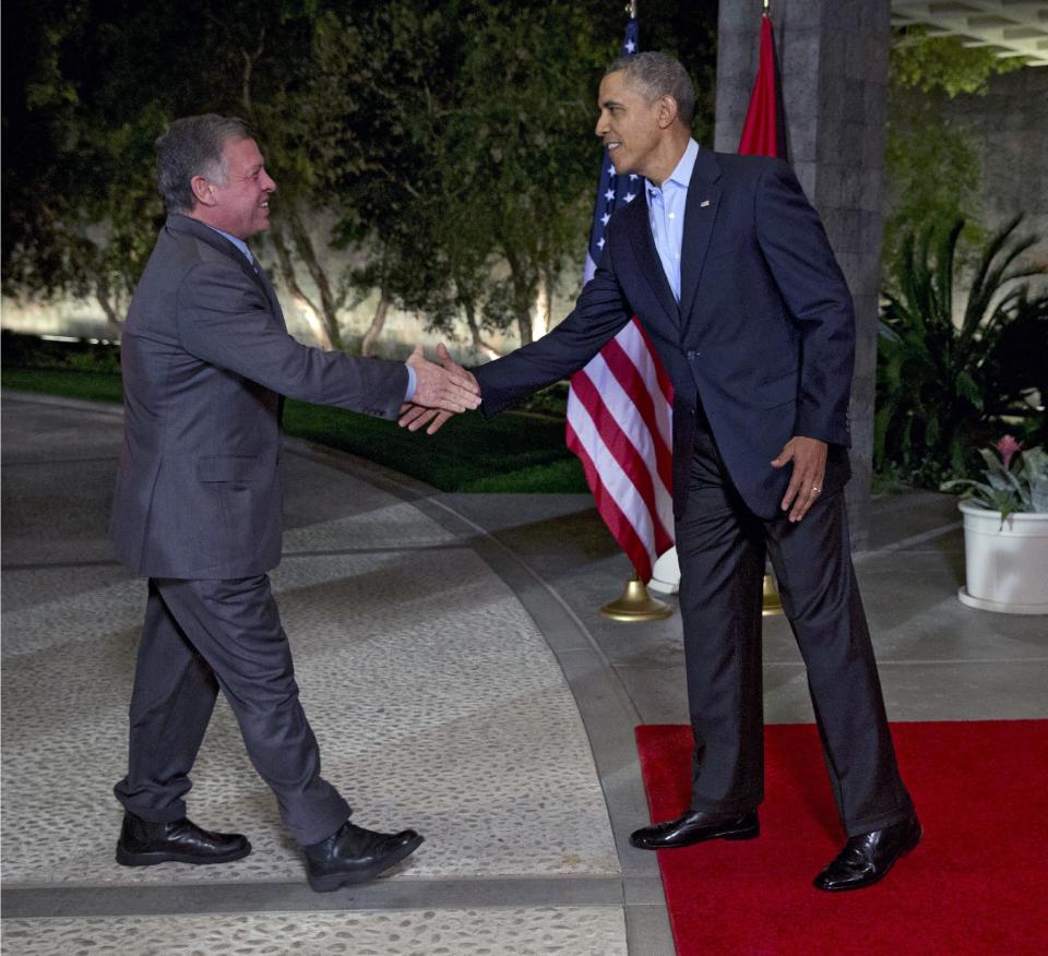 President Barack Obama, right, greets Jordan's King Abdullah II at The Annenberg Retreat at Sunnylands, Rancho Mirage, Calif., Friday, Feb. 14, 2014. (AP Photo/Jacquelyn Martin)