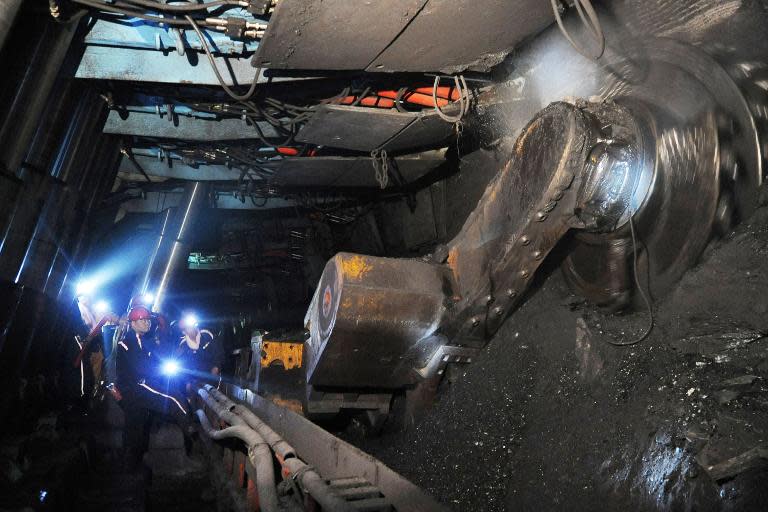 Laborers work at a coal mining facility in Huaibei, in northern China's Anhui province, on March 4, 2014