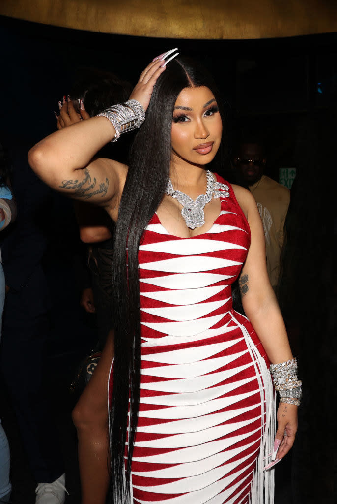 Cardi in a body-con sleeveless dress