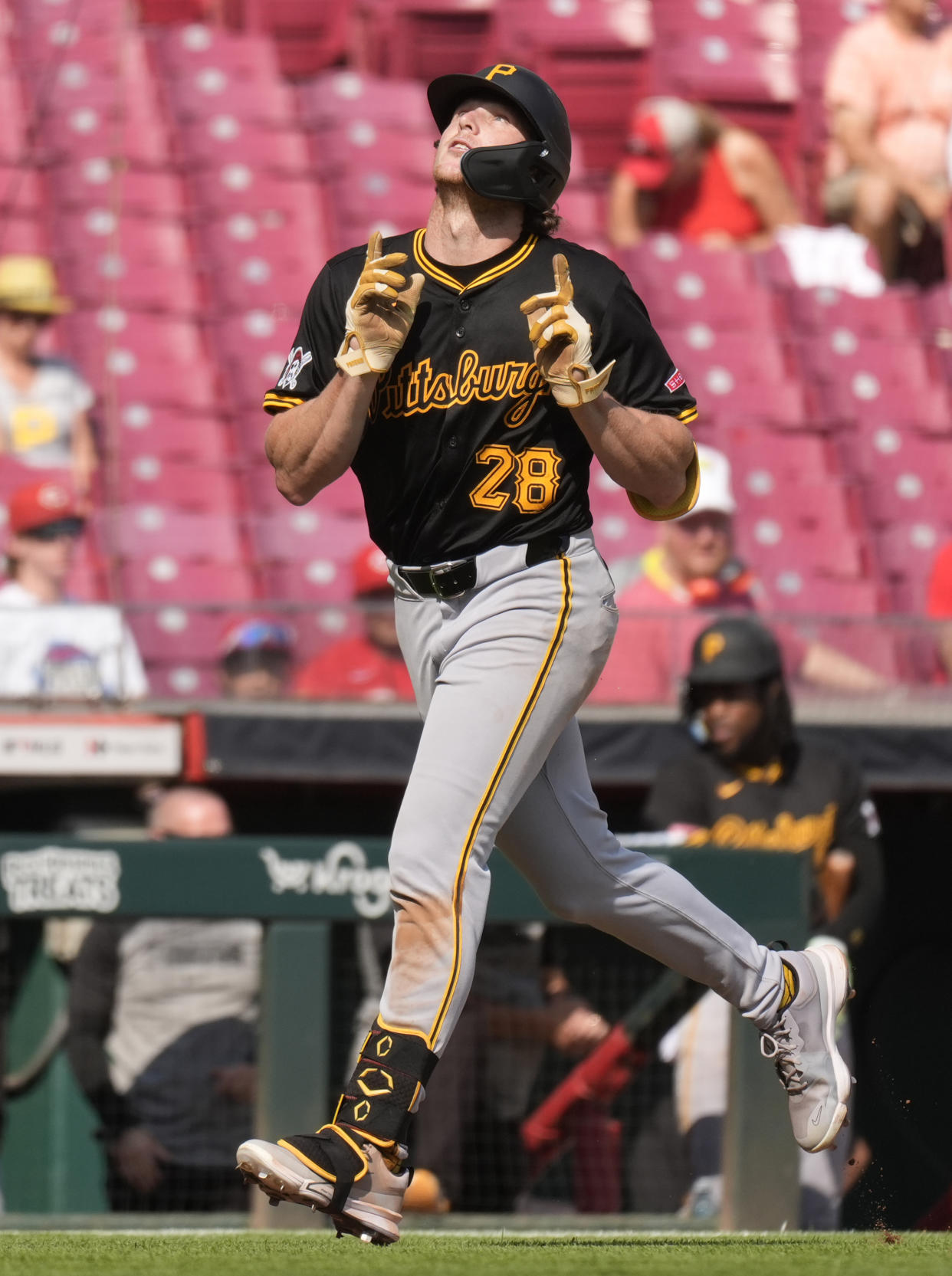 Pittsburgh Pirates' Billy Cook (28) looks to the sky as he rounds the bases after hitting a home run during the ninth inning of a baseball game against the Cincinnati Reds, Saturday, Sept. 21, 2024, in Cincinnati. The Reds won 7-1. (AP Photo/Carolyn Kaster)