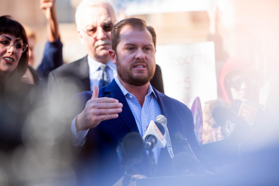 Sen. Jake Hoffman speaks to school voucher supporters and members of the media during a news conference outside the Arizona state Senate building in Phoenix on Jan. 8, 2024.