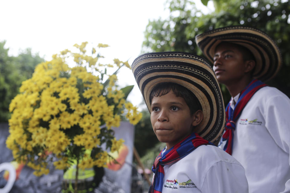 Boys from a music band attend a symbolic funeral ceremony for the late Colombian Nobel Literature laureate Gabriel Garcia Marquez in front of the church in Aracataca, his hometown in Colombia's Caribbean coast, Monday, April 21, 2014. Garcia Marquez died at the age of 87 in Mexico City on April 17, 2014. (AP Photo/Ricardo Mazalan)