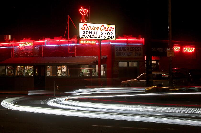 San Francisco, CA - Motor traffic streams along Bayshore Boulevard outside the Silver Crest Donut Shop Restaurant and Bar in San Francisco on a recent evening. George Giavris, 84, right, works behind the counter at the Silver Crest Donut Shop Restaurant and Bar in San Francisco. Owner George Giavris, 84, works up to 20 hours a day at the eatery. He bought the place in the 1970s and now suffers from spinal and leg pain. (Luis Sinco / Los Angeles Times)