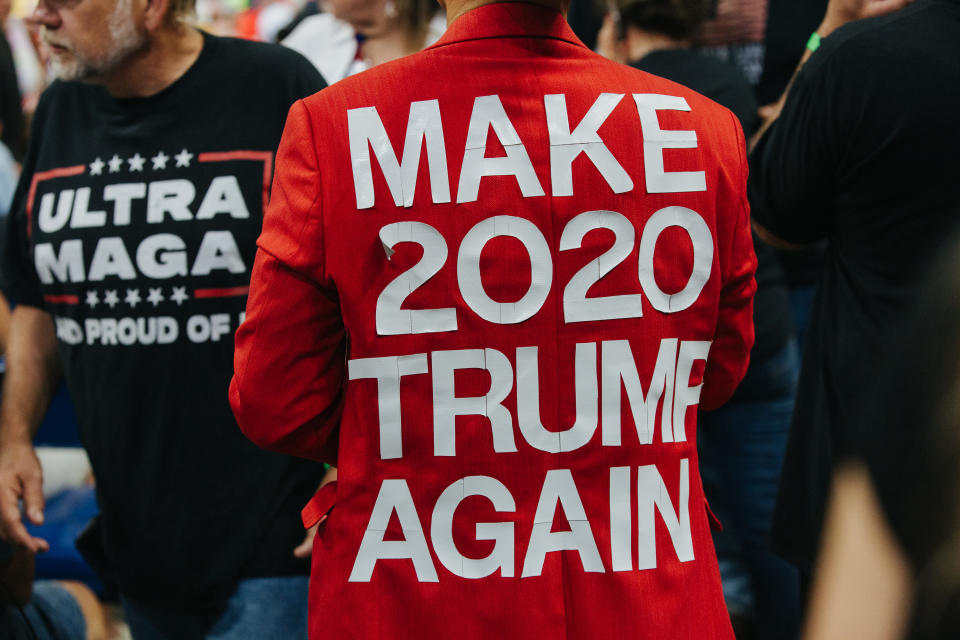 Attendees at a Trump rally wearing T-shirts saying: Ultra MAGA and Make 2020 Trump Again.