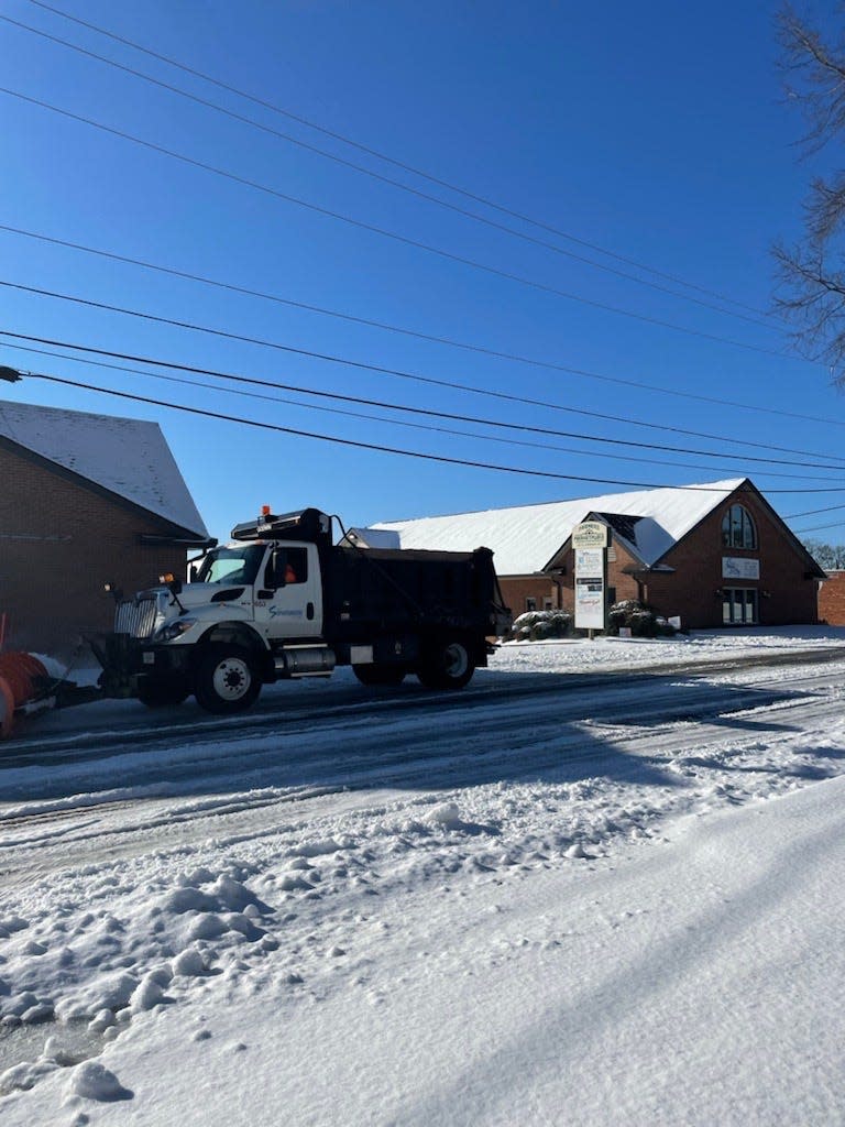 Spartanburg city crews plow Kennedy Street near Pine Street Monday morning. Most streets are still covered with snow and ice, officials said.