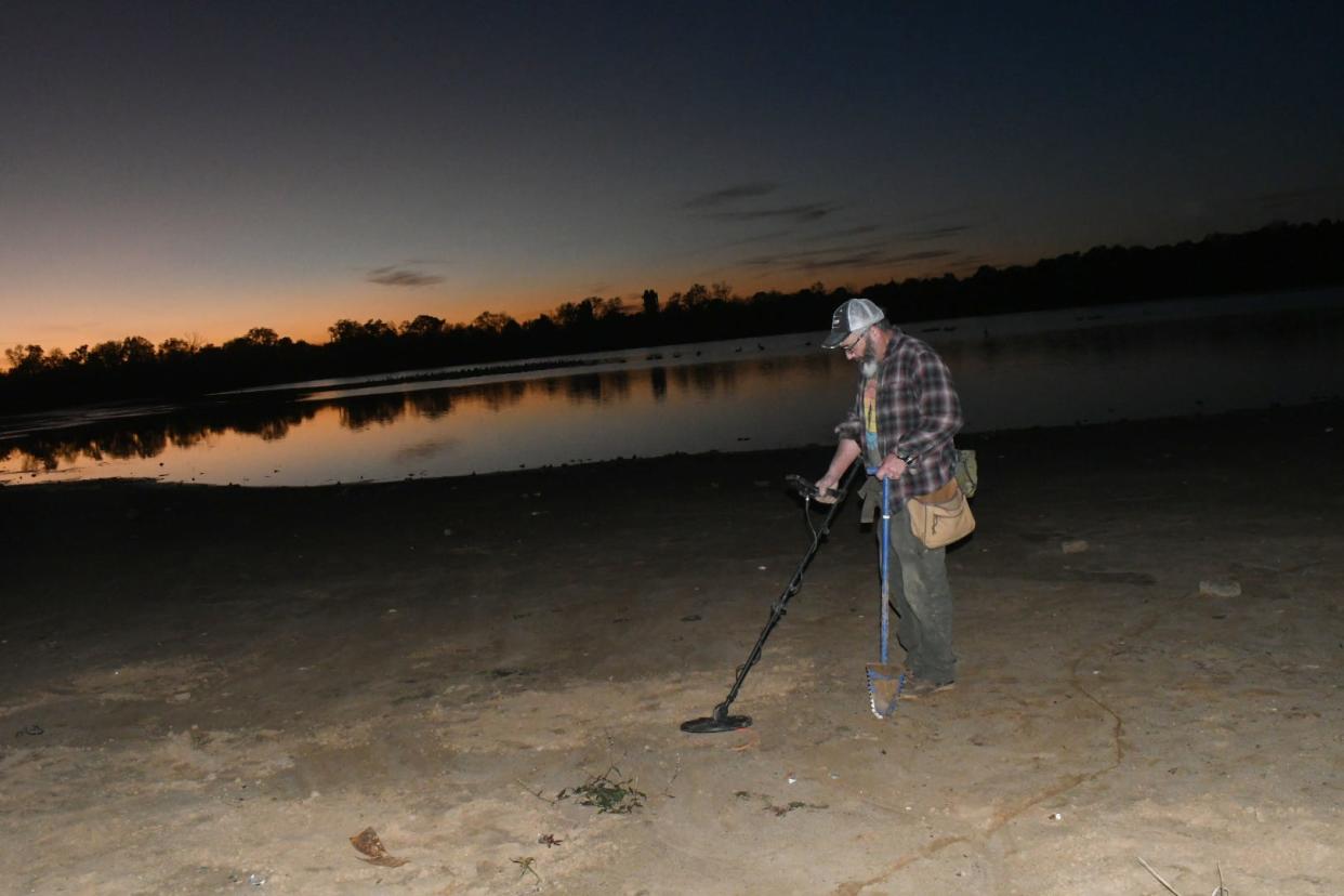 Pete Socia of Red River Relic Recovery combs the dry lake bed of Buhlow Lake with his metal detector to see what he could uncover.