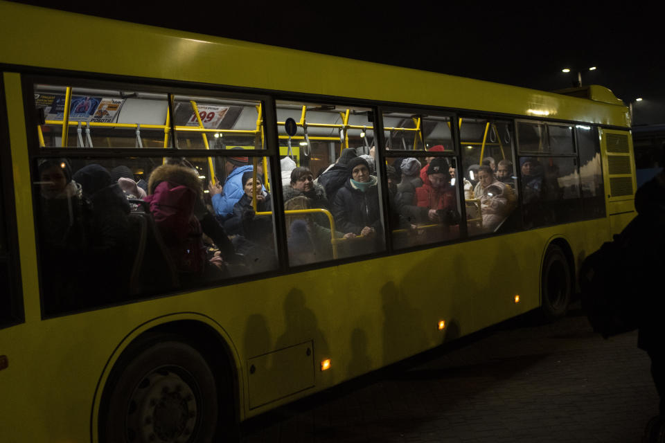 Displaced Ukrainians take a bus ride to Poland from Lviv train station in western Ukraine on Saturday, March 5, 2022. Russian troops took control of the southern port city of Kherson this week. Although they have encircled Kharkiv, Mykolaiv, Chernihiv and Sumy, Ukrainian forces have managed to keep control of key cities in central and southeastern Ukraine, Ukrainian President Volodymyr Zelenskyy said Saturday. (AP Photo/Bernat Armangue)