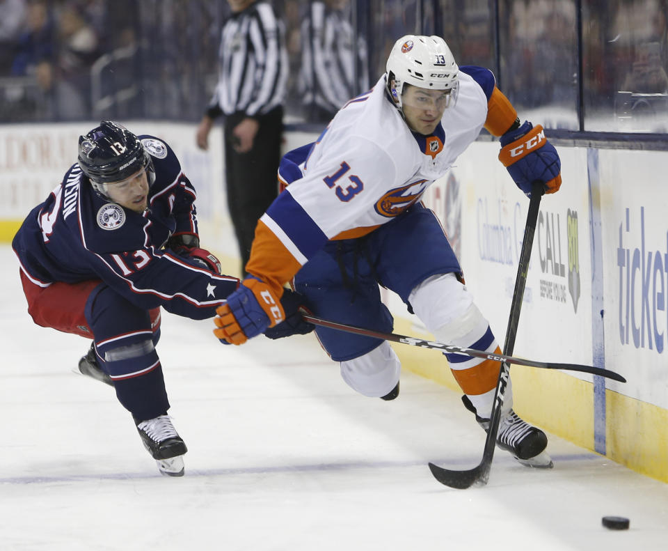 New York Islanders' Mathew Barzal, right, carries the puck across the blur line as Columbus Blue Jackets' Cam Atkinson defends during the first period of an NHL hockey game Thursday, Feb. 14, 2019, in Columbus, Ohio. (AP Photo/Jay LaPrete)