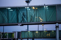 <p>Airport staff stand on a boarding bridge after the arrival of the inaugural Qatar Airways Ltd. flight to Chiang Mai International Airport in Chiang Mai, Thailand, on Wednesday, Dec. 13, 2017. Qatar Airways launched its new direct service from Doha to Chiang Mai today. The new seasonal service will operate 4 times a week with a flight time of just over six hours. Photograph: Taylor Weidman/Bloomberg </p>