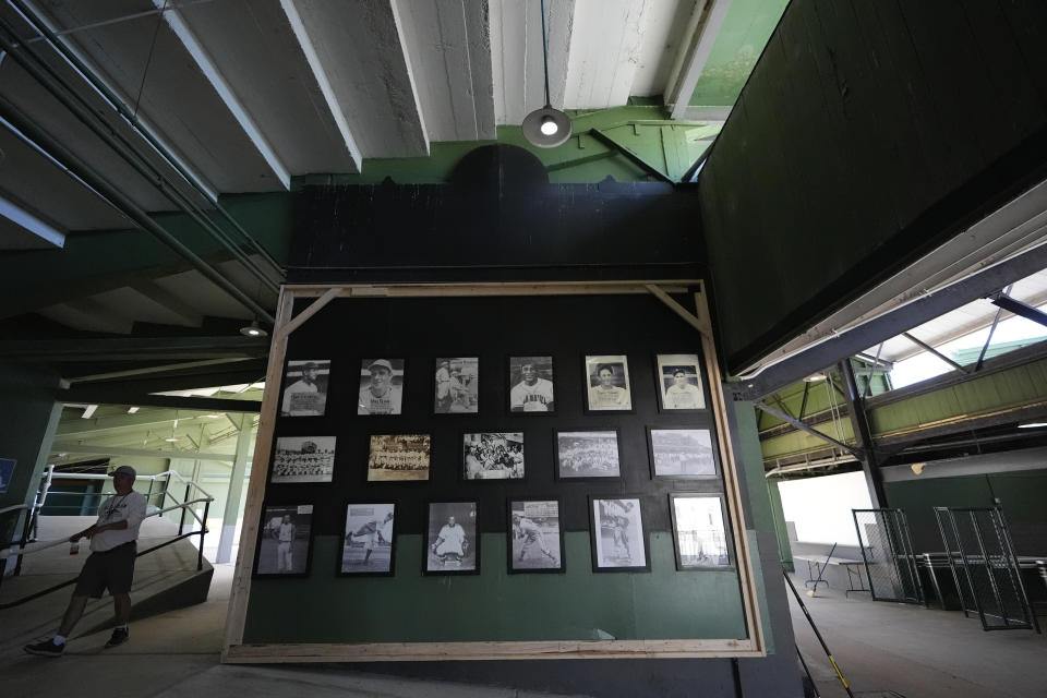 A person walks by a Rickwood Field, "hall of fame," said to be former players of the baseball field, Monday, June 10, 2024, in Birmingham, Ala. Rickwood Field, known as one of the oldest professional ballpark in the United States and former home of the Birmingham Black Barons of the Negro Leagues, will be the site of a special regular season game between the St. Louis Cardinals and San Francisco Giants on June 20, 2024. (AP Photo/Brynn Anderson)