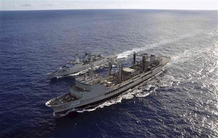 The Australian Navy ship HMAS Success (front) performs a Replenishment at Sea evolution with the Royal Malaysian Navy ship KD Lekiu, providing it with more fuel during the continuing search for the missing Malaysian Airlines flight MH370, in the southern Indian Ocean in this picture released by the Australian Defence Force on April 8, 2014. REUTERS/Australian Defence Force/Handout