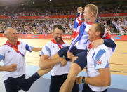 Britain's Chris Hoy is carried by officials as they celebrate after the track cycling men's keirin finals at the Velodrome during the London 2012 Olympic Games August 7, 2012. Hoy won the gold medal. REUTERS/Stefano Rellandini (BRITAIN - Tags: OLYMPICS SPORT CYCLING)