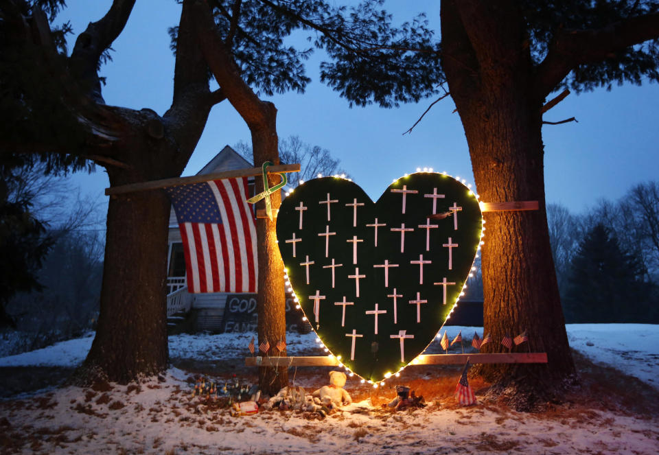 FILE - A makeshift memorial with crosses for the victims of the Sandy Hook Elementary School shooting massacre stands outside a home on the first anniversary of the tragedy in Newtown, Conn., Dec. 14, 2013. Connecticut Gov. Ned Lamont on Tuesday, June 6, 2023, signed the most wide-ranging state gun control bill since a 2013 law passed in the aftermath of the Sandy Hook Elementary School shooting, sparking an immediate lawsuit by gun rights supporters seeking to block a ban on open carrying and other parts of the new law. (AP Photo/Robert F. Bukaty, File)