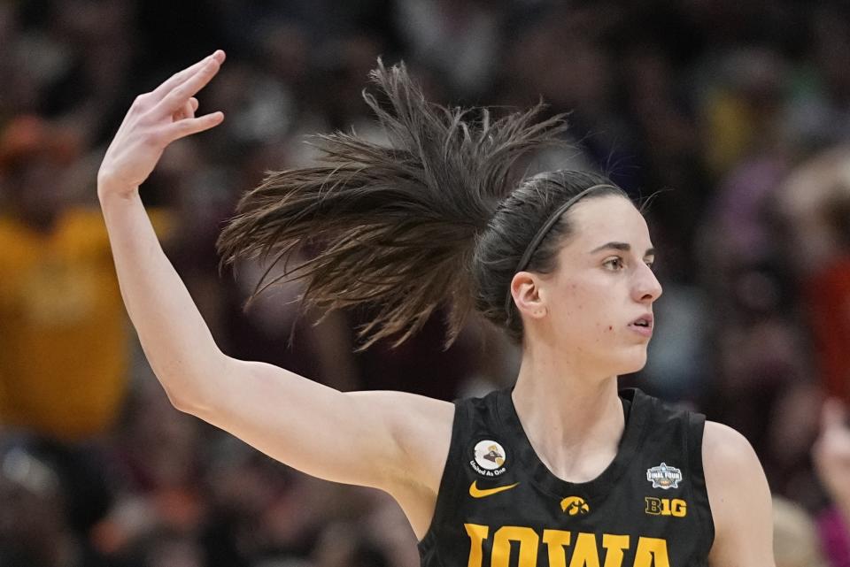 Iowa's Caitlin Clark reacts after a three pointer during the second half of an NCAA Women's Final Four semifinals basketball game against South Carolina Friday, March 31, 2023, in Dallas. (AP Photo/Darron Cummings)