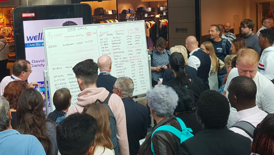 <em>Passengers at Gatwick Airport had to check whiteboards for flight details due to an IT failure (Twitter/@hunterruthven)</em>