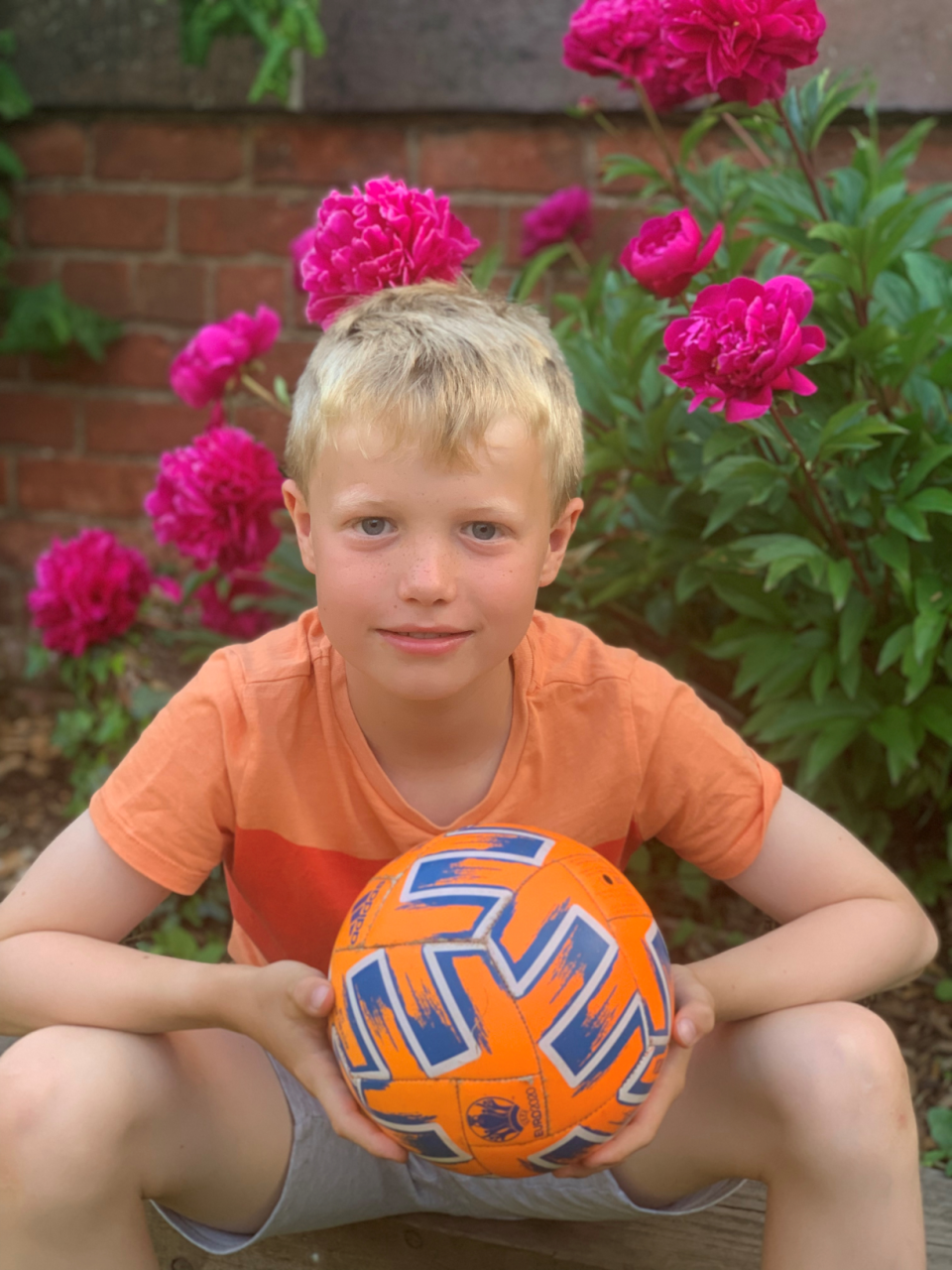 Thomas Braun sitting with a football