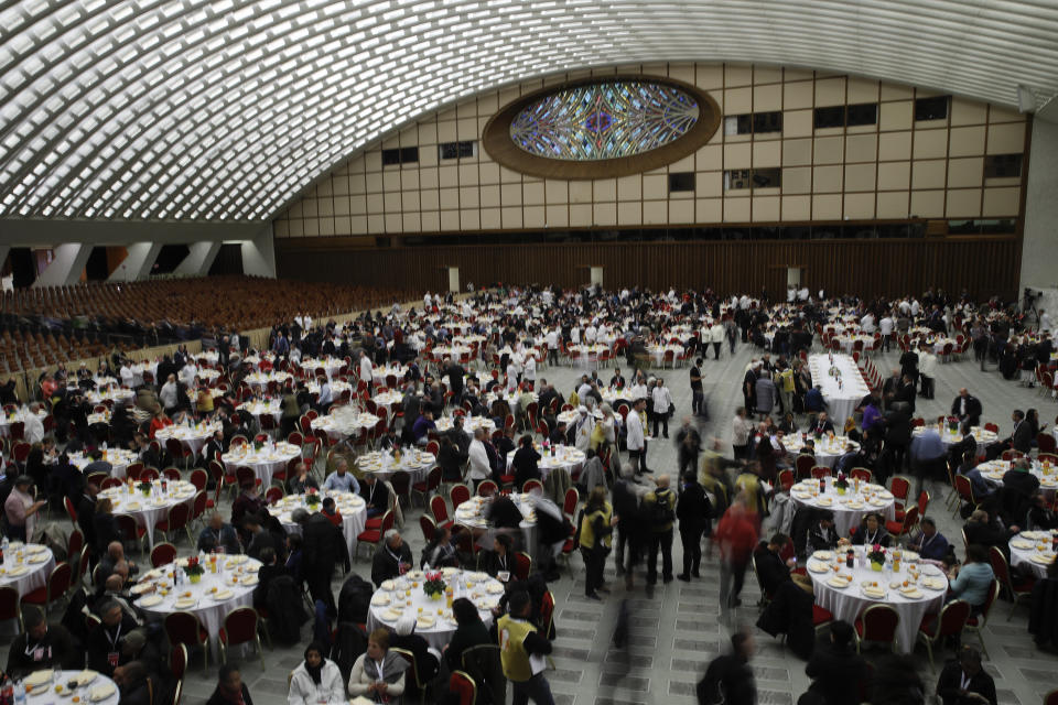 People wait for Pope Francis arrival for a lunch in the Paul VI Hall at the Vatican, Sunday, Nov. 17, 2019. Pope Francis is offering several hundred poor people, homeless, migrants, unemployed a lunch on Sunday as he celebrates the World Day of the Poor with a concrete gesture of charity in the spirit of his namesake, St. Francis of Assisi. (AP Photo/Alessandra Tarantino)
