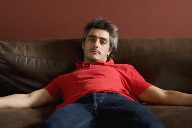 Man slouching on sofa