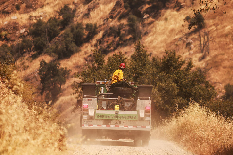 Image: A crew from the Sierra Hot Shots rides through as the Basin Fire burns  (David Swanson / AFP - Getty Images)