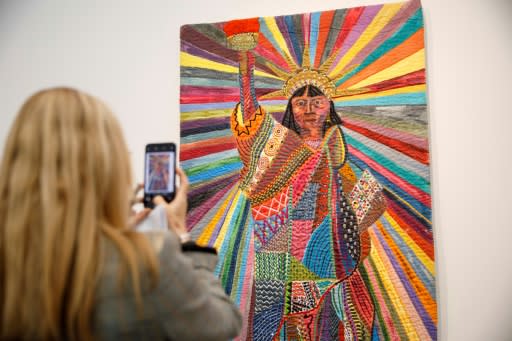 A visitor snaps Pacita Abad's 'L.A. Liberty', a work by an American-Filipino artist renowned for merging�traditional textiles with contemporary painting