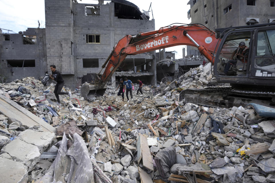 Palestinians search for the bodies of the al Meghari family killed in the Israeli bombardment of the Gaza Strip in Bureij refugee camp, Gaza Strip, Tuesday, Nov. 14, 2023. U.N. humanitarian monitors say at least 2,700 people, including 1,500 children, are missing and believed buried under the rubble. (AP Photo/Adel Hana)