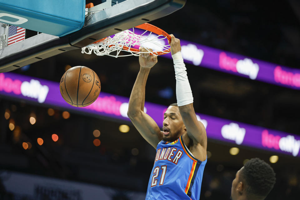 Oct 15, 2023; Charlotte, North Carolina, USA; Oklahoma City Thunder guard Aaron Wiggins (21) dunks against the Charlotte Hornets during the first half at Spectrum Center. Mandatory Credit: Nell Redmond-USA TODAY Sports