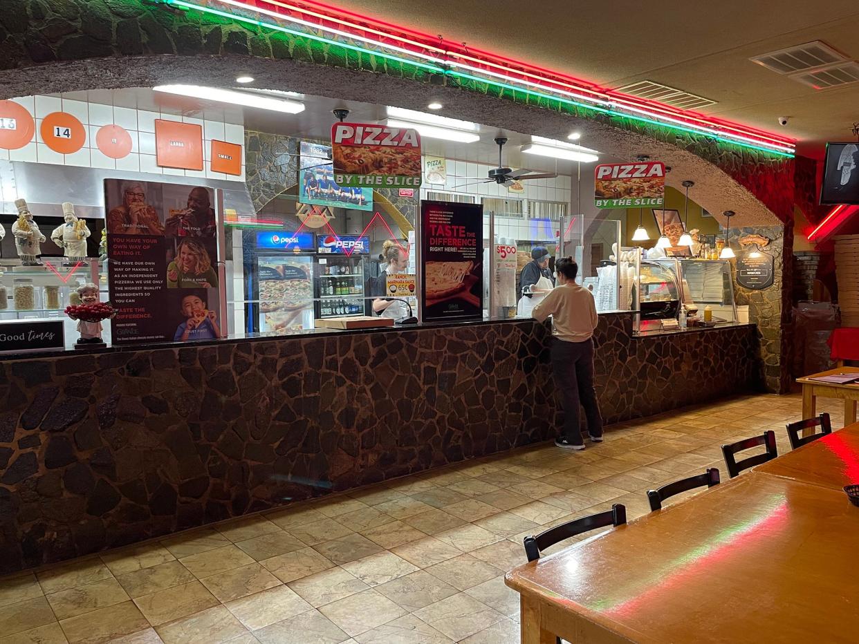 A customer places an order at the counter before the lunchtime rush at Peppino's Pizzeria in Athens, Ga. on Thursday, Nov. 16, 2023.