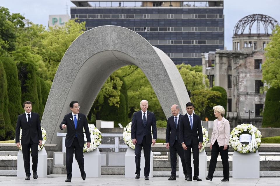 G7 nations' leaders, from left to right, French President Emmanuel Macron, Japanese Prime Minister Fumio Kishida, U.S. President Joe Biden, German Chancellor Olaf Scholz, Britain's Prime Minister Rishi Sunak, and European Commission President Ursula von der Leyen walk to get into place after laying a wreath, at the Peace Memorial Park during a visit as part of the G7 Summit in Hiroshima, western Japan Friday, May 19, 2023. (Kenny Holston/Pool Photo via AP)