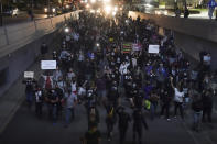 Protesters march, Thursday, Sept. 24, 2020, in Louisville, Ky. Authorities pleaded for calm while activists vowed to fight on Thursday in Kentucky's largest city, where a gunman wounded two police officers during anguished protests following the decision not to charge officers for killing Breonna Taylor. (AP Photo/John Minchillo)