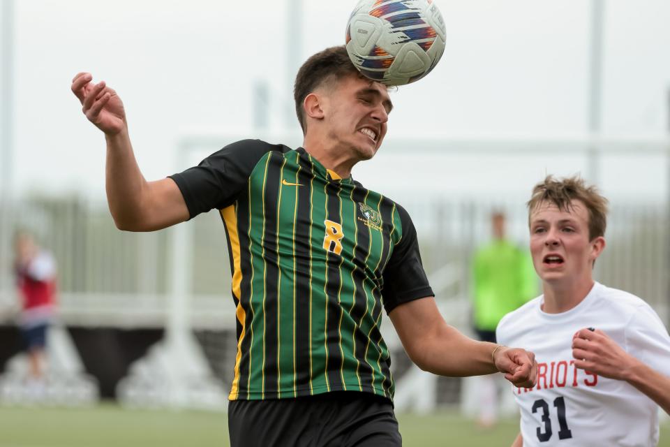 St. Joseph’s Arthur Sandri heads the ball ahead of American Heritage’s Spencer Thompson in a 2A boys soccer state semifinal at Zions Bank Stadium in Herriman on Wednesday, May 10, 2023.