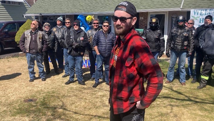 Matt Small, 21, in front of his Levittown house, surrounded by members of the Bucks County Riders, who escorted him home.