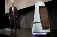 <p>David VanderWaal, VP of marketing for LG Electronics USA, is approached by the new LG Airport Guide Robot during the LG press conference at CES in Las Vegas, U.S., January 4, 2017. The robot will soon be in Seoul’s Incheon International Airport to answer traveller questions in English, Chinese, Japanese and Korean, and provide information about flight boarding times, estimated distances and walking times, and weather in the traveller’s destination city. (Reuters) </p>